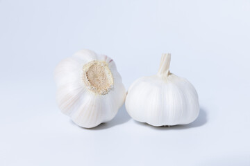 Obraz na płótnie Canvas Fresh garlic herb food on a white background.This culinary ingredient adds natural flavor and aroma to your meals. Ideal for gourmet cooking and food styling. A tasty addition to any recipe.