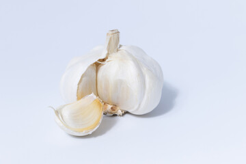 Fresh garlic herb food on a white background.This culinary ingredient adds natural flavor and aroma to your meals. Ideal for gourmet cooking and food styling. A tasty addition to any recipe.