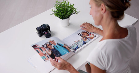 Woman Looking At Photo Album