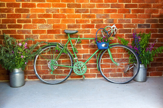 Retro style bicycle with flowers as creative decoration in the cozy small street
