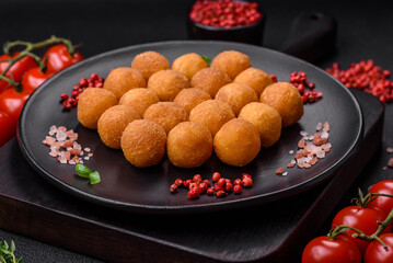 Delicious fried potato balls with breaded mozzarella, salt, spices and herbs