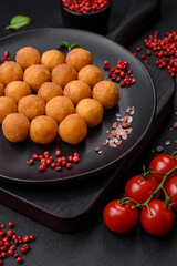 Delicious fried potato balls with breaded mozzarella, salt, spices and herbs