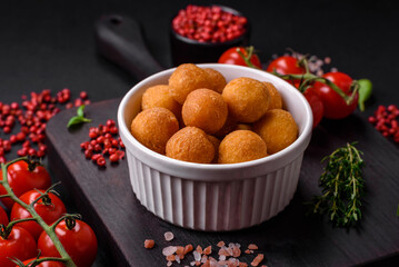 Delicious fried potato balls with breaded mozzarella, salt, spices and herbs
