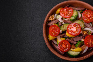 Delicious fresh salad with beef slices, cherry tomatoes, sweet peppers