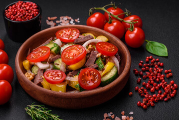 Delicious fresh salad with beef slices, cherry tomatoes, sweet peppers