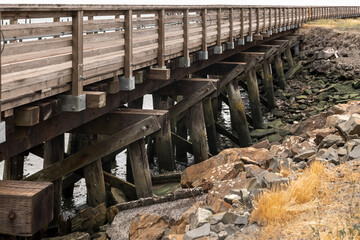 Fototapeta na wymiar Close up view of wooden boardwalk structure at Astoria sea side, Oregon.