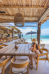 Traveler asian woman travel and relax in beach cafe at Koh Samui summer Thailand - 621463118