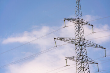 High voltage towers with sky background. Power line support with wires for electricity transmission. High voltage grid tower with wire cable at distribution station. Energy industry, energy saving