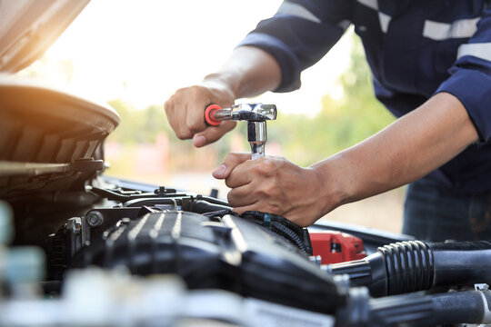 Automobile mechanic repairman hands repairing a car engine automotive workshop with a wrench, car service and maintenance,Repair service.