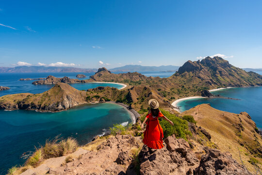 Young female tourist enjoying the beautiful landscape at Padar island in Komodo National Park, Indonesia