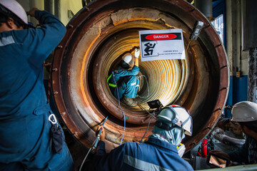 Male worker inspection measured the coil pipe circular thickness of the boiler scan minimum thickness into symbol dangerous confined