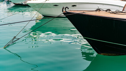 The bow of a boat in calm blue waters
