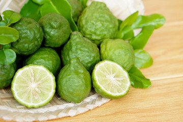 Bergamot fruits and leaves on  wooden background. Concept, herbal fruits with sour taste, can be cooked as food seasoning and use for spa , aroma. Medicinal herb.                 