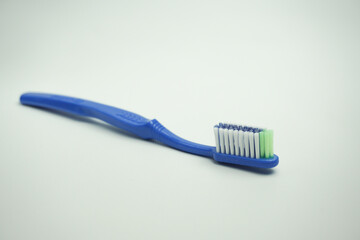 blue plastic toothbrush, the top view, sideways and in the long term, on a white background