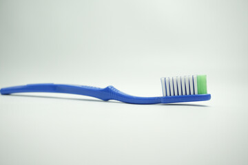 blue plastic toothbrush, the top view, sideways and in the long term, on a white background