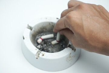 Partial view of smoking man putting out cigarette in ashtray isolated on white