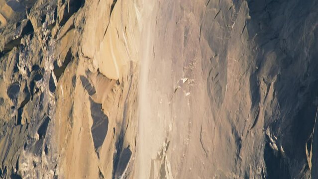 Camera moving down of Yosemite Firefalls in Yosemite valley, Yosemite National Park, California, USA. Close shot of Horsetail fall occurs on the east side of El Capitan rock formation, 4k footage 