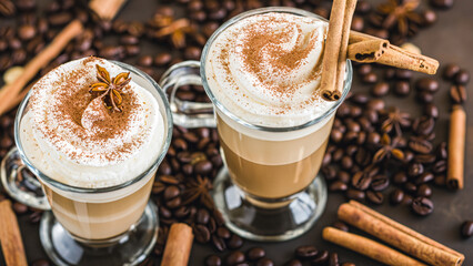 caffe latte with whipped cream, cinnamon and anise in a glass