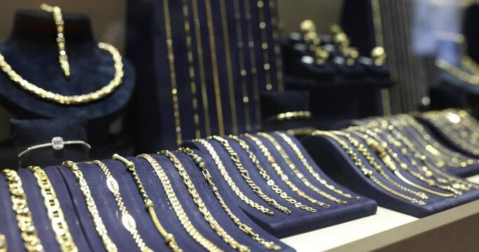 Assortment of gold jewelry in jewelry store closeup. Rating and selection of quality jewelry