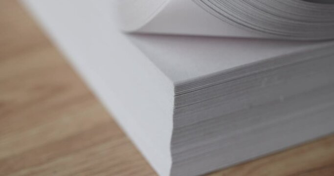 Hand flips through stack of white blank sheets of paper. Finding document in business documentation