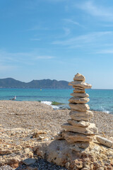 Fototapeta na wymiar Sculpture of superimposed stones in Mallorca beach