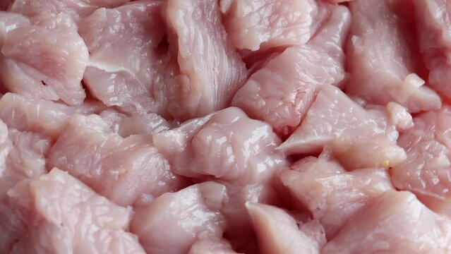 pieces of raw turkey meat , rotation in circle. fillet turkey Turning. selective focus