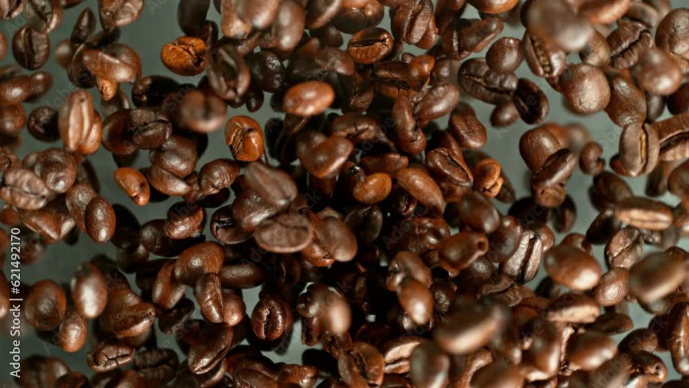Poster super slow motion of rotating coffee beans on black background. filmed on high speed cinema camera, 
