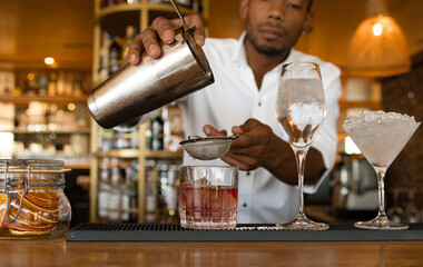 Fototapeta na wymiar latin bartender making some cocktails