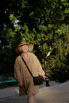 Full Body Of Happy Older Woman With Hat Outdoors