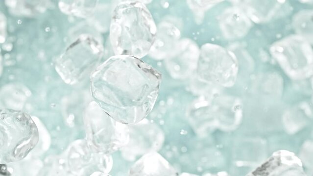 Super slow motion of rotating ice cubes, top view shot. Filmed on high speed cinema camera, 1000 fps, placed on high speed cine bot, following the object. Speed ramp effect.