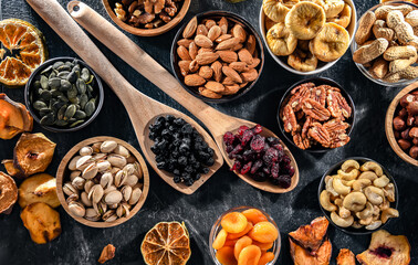 Composition with a variety of dried fruits and assorted nuts.