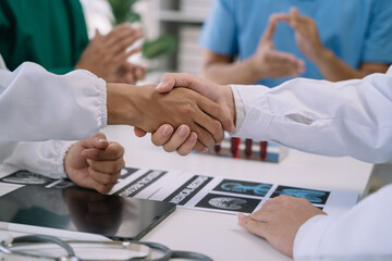 Doctor and Nursing assistant patient meeting at the hospital and shaking hands, healthcare and medicine banner in the morning.