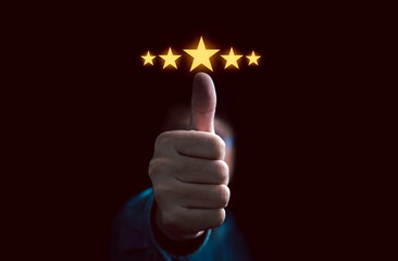 Businessman hand thumb up with glowing yellow five stars for client the best satisfaction...