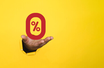 Businessman holding red zero percentage or 0 percent in yellow bankground and copy space for...