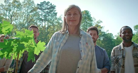 Team of young multicultural volunteer enjoy charitable social work in tree forest planting. NGO work for fighting climate change and global warming in environmental project