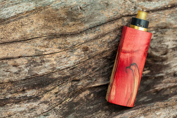 high end red natural stabilized wood regulated box mods with rebuildable dripping atomizer on...