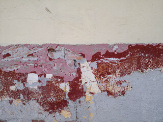wall, half painted, half plastered. Brick visible from partially poured plaster. rusty pastel colors
