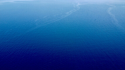 Deep blue sea. Blue sea surface background. Marine texture. Aerial view of the sea surface and small waves.