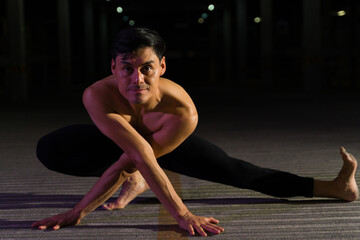Fototapeta na wymiar Artistic dramatic male dancer doing a contemporary dance