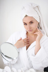 Portrait of a beautiful young woman in a bathrobe after a shower