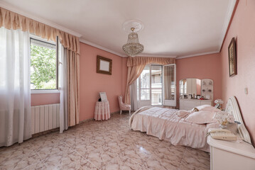 A spacious bedroom with a garish pink