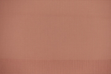 Sewing texture of pale orange synthetic material