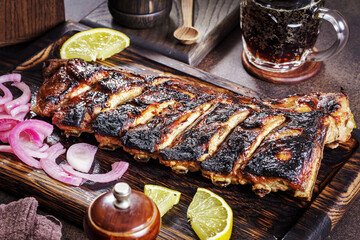 Grilled caramelized pork ribs on wooden tray