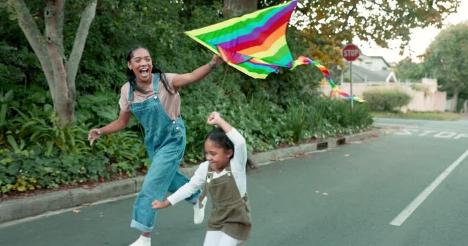 Family, flying a kite and girl with her mother outdoor together on the street for carefree or playful bonding. Kids, love and a woman running with her excited daughter while playing a game in summer
