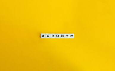 Acronym Word on Block Letter Tiles on Yellow Background. Minimal Aesthetic.