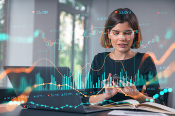 Pensive attractive beautiful businesswoman in working on laptop, talking phone, office workplace in background. Forex graph and charts hologram icons. Concept of market trading and research.