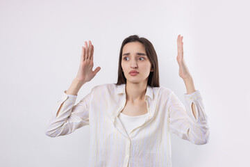 Young beautiful woman with facial expression of surprise standing over white background.