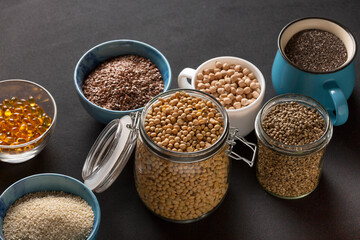 Source of vitamin E and nutrients in bowls on the table, copy space
