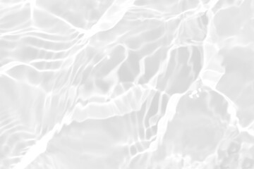 Obraz premium White water with ripples on the surface. Defocus blurred transparent white colored clear calm water surface texture with splashes and bubbles. Water waves with shining pattern texture background.