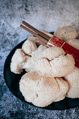 Hericium erinaceus or Lions mane mushroom with a Chinese chopsticks. © stivog